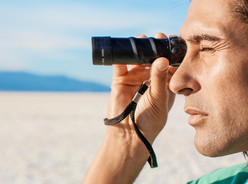Man using a monocular for viewing sports