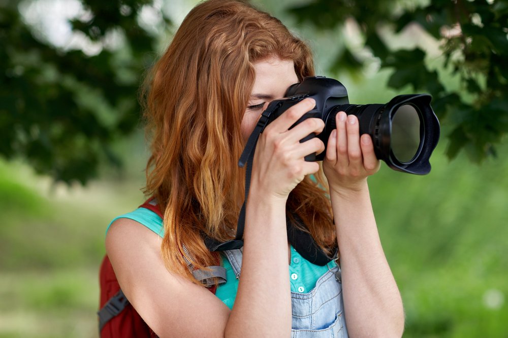 a woman capturing the beauty of the environment
