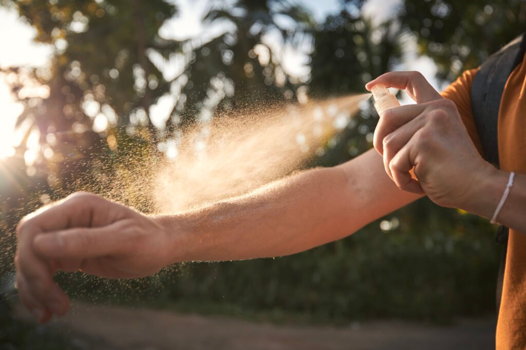 Man applying insect repellent on his hand